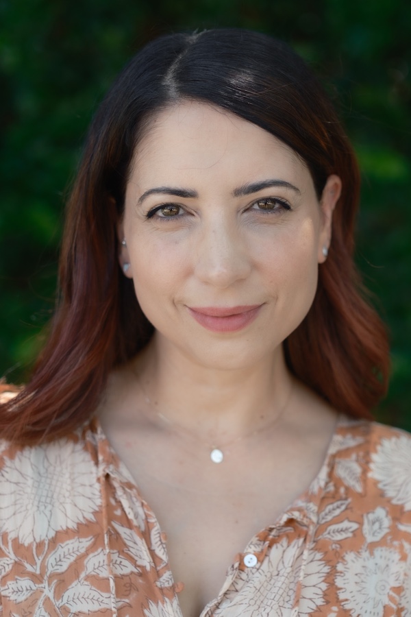 Sonia Scali, Counsellor looking to camera with a warm, welcoming smile, wearing an umber and white floral pattern shirt.